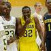 Michigan senior Corey Person, laughs as he stands with teammates Caris LeVert and Glenn Robinson III during media day at the Player Development Center on Wednesday. Melanie Maxwell I AnnArbor.com